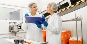 women technologists tasting ice cream at factory